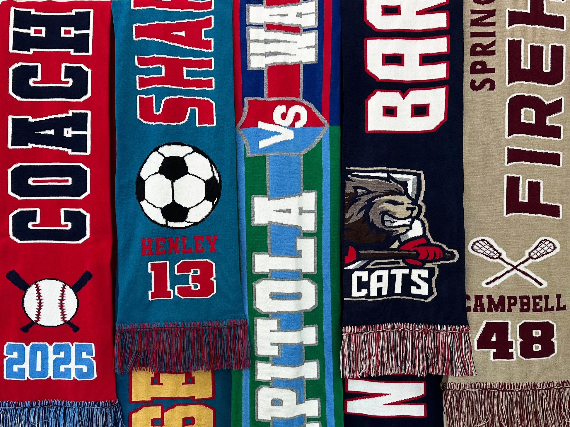 Collection of sports-themed scarves with various designs and text.